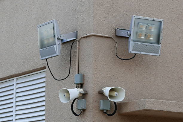 istock Loudspeaker or megaphone and spotlight attached to wall. 1306692903
