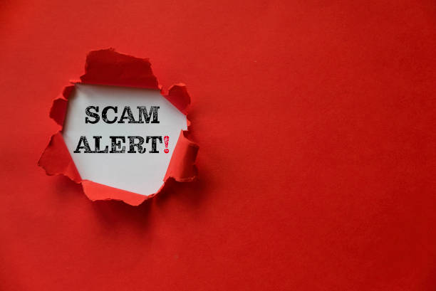 Red torn paper with a text of Scam Alert with copy space. stock photo