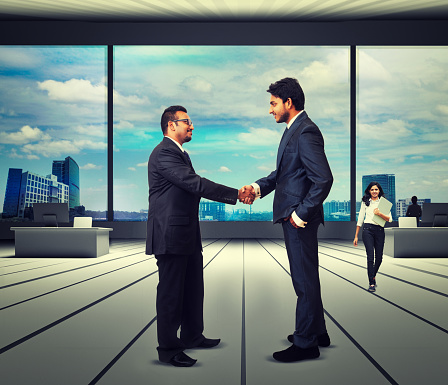 Shot of two businesspeople shaking hands in an office