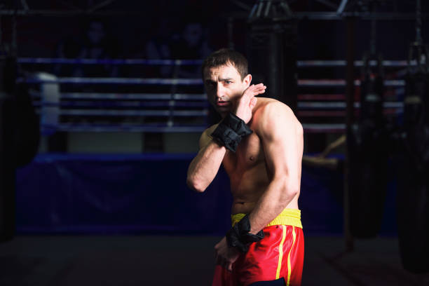 istock Man is practicing kick in a boxing gym 1306696058