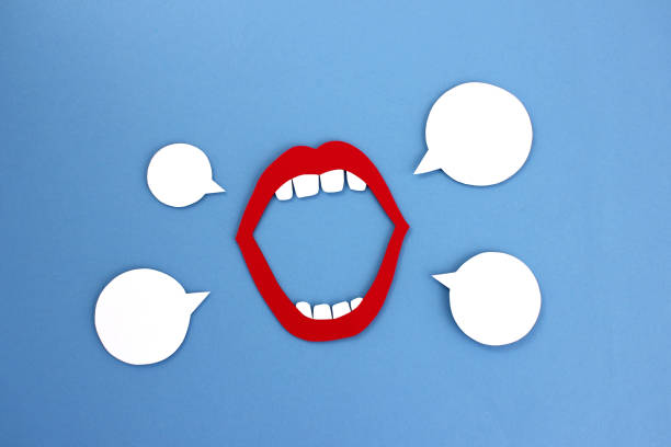 Paper mouth with blank speech bubbles Paper cutout of open mouth with red lips and white teeth placed near empty speech balloons on blue background gossip stock pictures, royalty-free photos & images