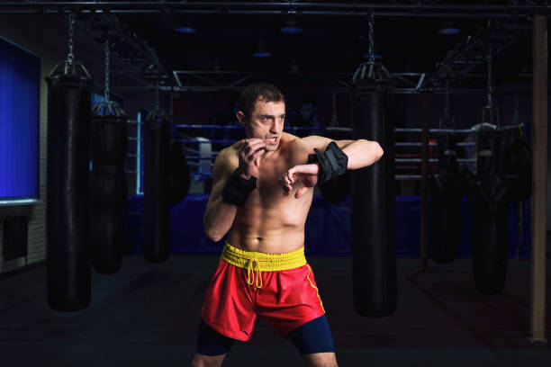 istock Man is practicing kick in a boxing gym 1306696246
