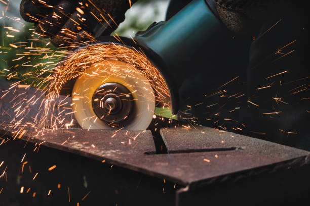 istock grinding cutting metal sheet with angle grinder machine and sparks, Close up 1306701903