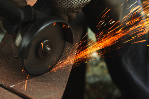 istock grinding cutting metal sheet with angle grinder machine and sparks, Close up 1306701909