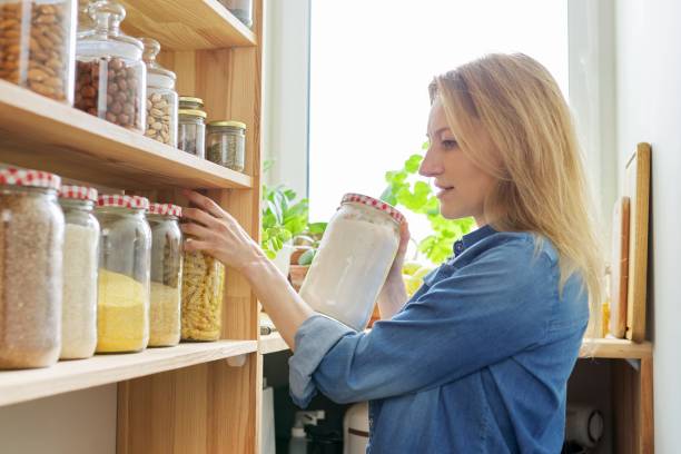 istock Middle aged woman at home in kitchen in pantry 1306702761