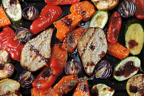 istock Baked vegetables and fruits on a baking sheet. 1306703829