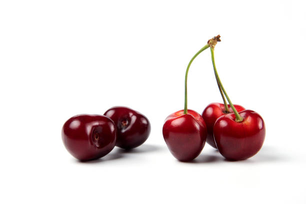 istock Red and black cherries on white background 1306705301