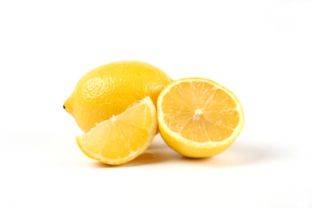 istock Yellow fresh lemon cut into pieces macro view 1306705386