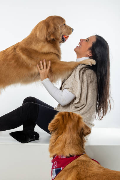 istock woman playing with dog on white background 1306706689