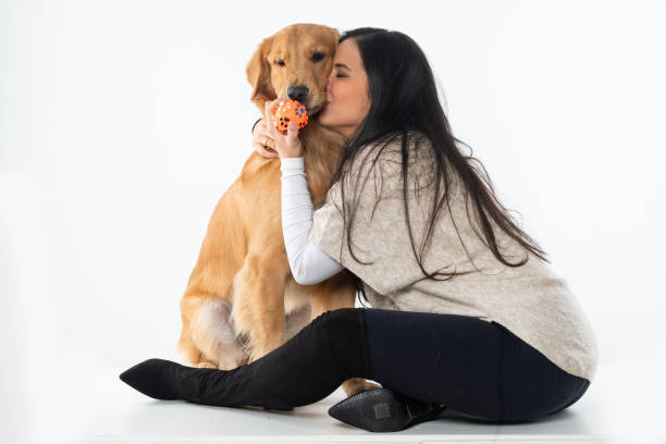 istock woman playing with dog on white background 1306706706