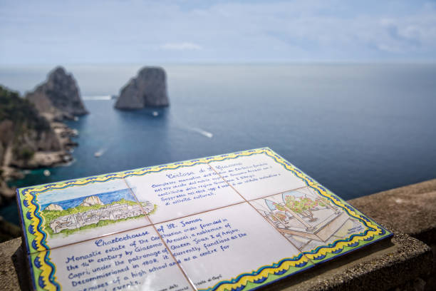 Capri Island, Tyrrhenian sea, Italy - May 19, 2016: A ceramic tile information sign showing to the Faraglioni Rocks