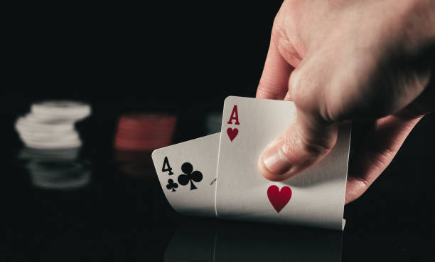 Hand discovering two poker cards Hand discovering two poker cards in Madrid, MD, Spain discover card stock pictures, royalty-free photos & images