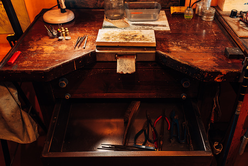 The workbench where a jewellery artist moulds and finishes his works of art. The workplace of a gold and silver craftsman. Jewelry tools.