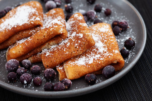istock Pancakes on a plate with coconut flakes on them and with frozen black currant around them 1306712370