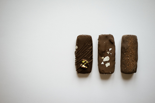 three chocolate candies on a white background in Kyiv, Kyiv City, Ukraine