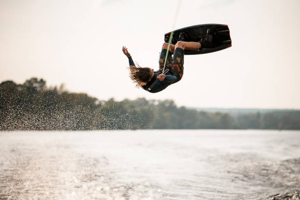 istock view on active male wakeboarder doing somersault in the air above water 1306714553