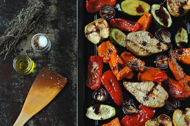 istock Baked vegetables and fruits on a baking sheet. 1306714811