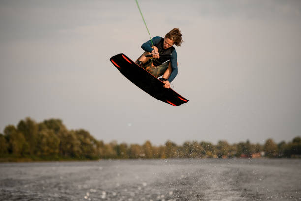 istock young sportive guy wakeboarder jumping high over river water 1306714902
