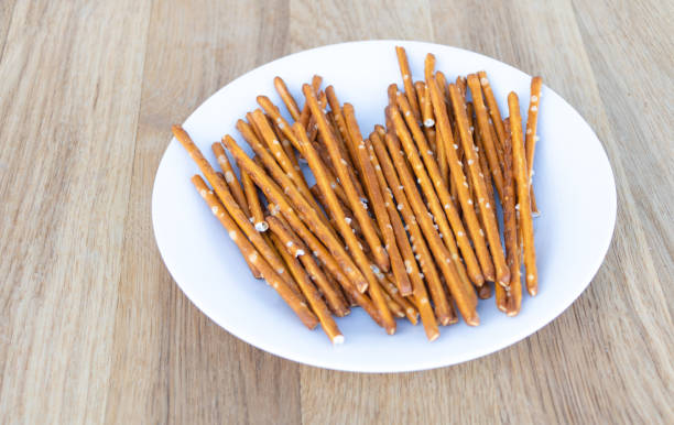 istock Dry sticks with salt in a plate on wooden background 1306715676