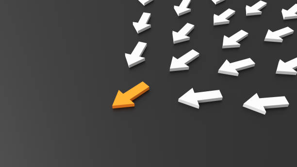 istock Leadership concept, orange leader arrow leading white arrows, on black background with empty copy space on left side 1306716012