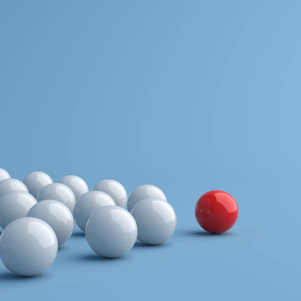 istock Leadership concept, red leader ball leading white balls, on blue background with empty copy space 1306716732