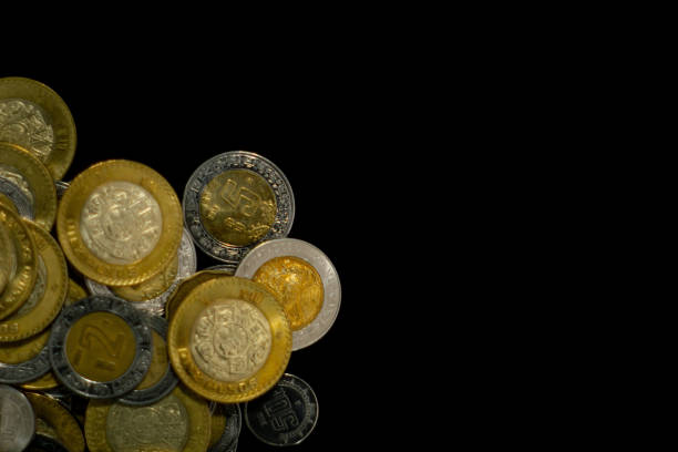 istock lot of mexican coins with black background 1306717559