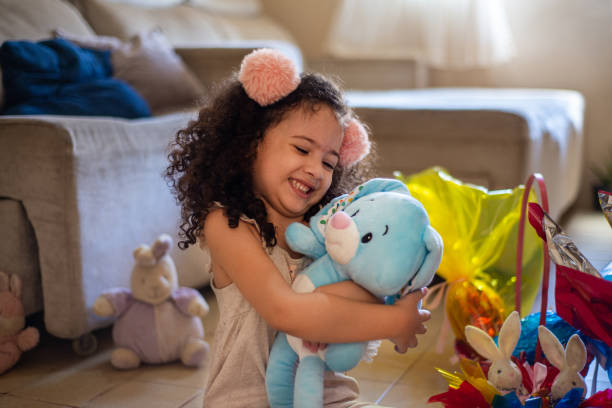 istock Small girl child hugging plush rabbit on Easter holiday 1306718256