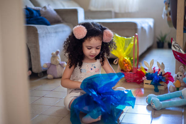 istock Cute little child. Girl eating chocolate easter egg 1306718279