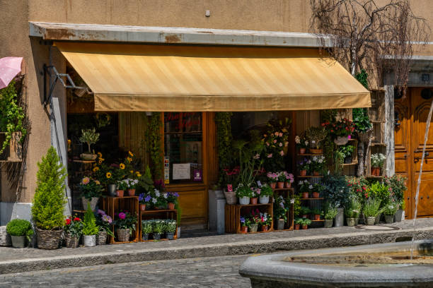 Ancient flower shop with sunshade at sunny day. 19. July 2019 - Villeneuve Switzerland. stock photo