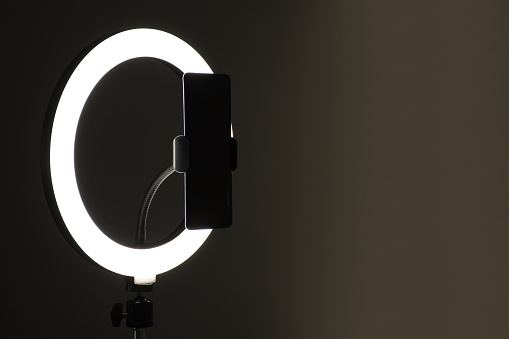Selfie ring light LED lamp with smart phone in the dark background