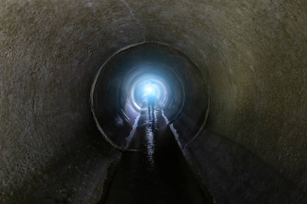 istock Flooded vaulted sewer tunnel with water reflection 1306722044
