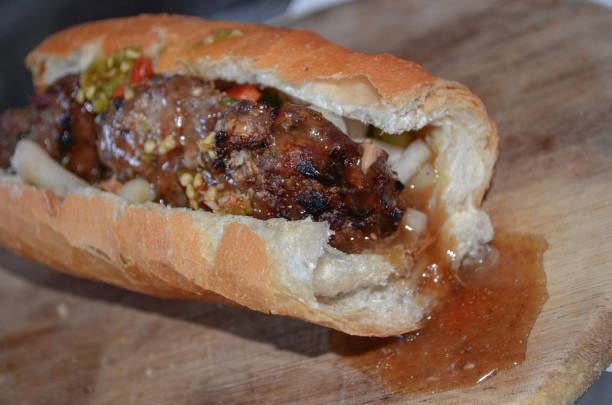 Baguette and grilled meatballs in Cambodia gravy style with grounded green chilli sauce Called : Nom pang or Num Pang