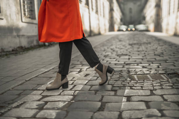 istock Female legs at a pedestrian crossing 1306728038