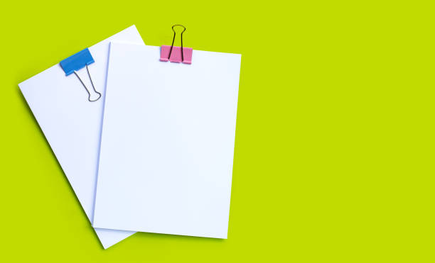 istock Stacking of business document with colorful binder clips on green background. 1306741170