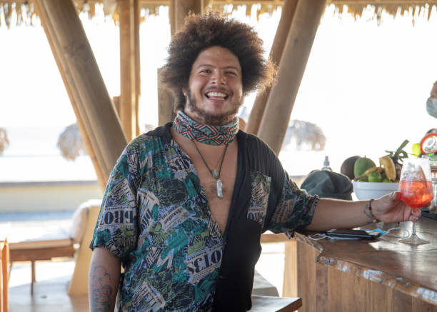istock Young man enjoys an Spritz at a tropical, outdoor bar 1306741495