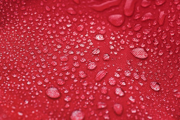 istock Red waterproof cloth covered with water drops 1306746106