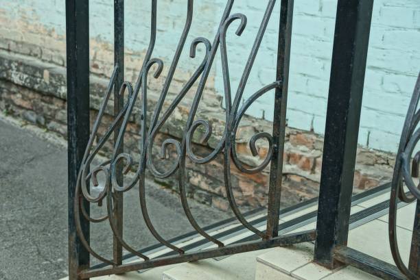 istock black iron handrails with a wrought pattern over gray concrete steps on the street 1306750715