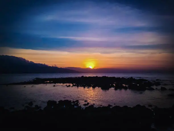 Beautiful Sunset Panorama On Tropical Rocky Fishing Beach In The Evening At Umeanyar Village, North Bali, Indonesia