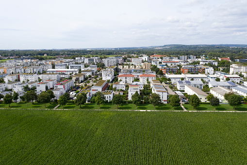 Housing development and green field in spring, aerial view.