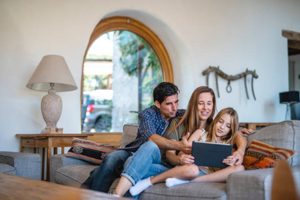 istock Parents Spending Time with Young Daughter and Digital Tablet 1306762529