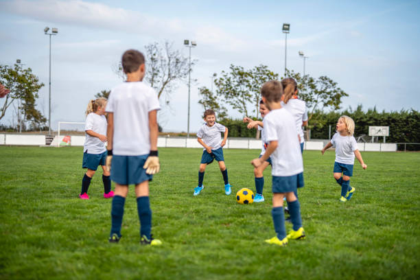 istock Young Footballers Doing Passing Drill During Training Camp 1306763712