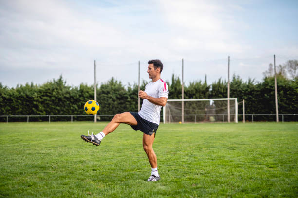 Mature Male Footballer Practicing Juggling for Ball Control