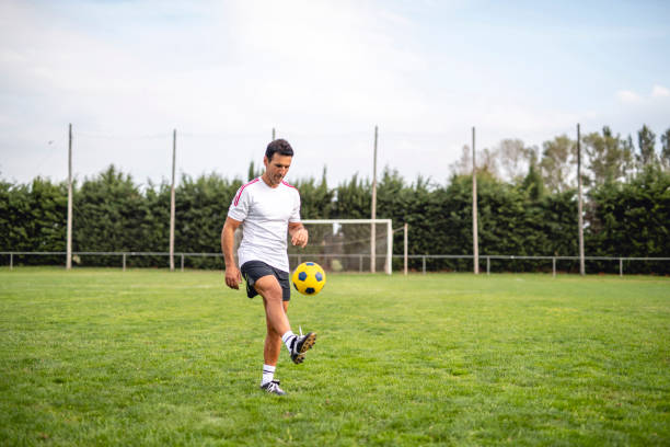 istock Mature Male Footballer Practicing Juggling for Ball Control 1306763786