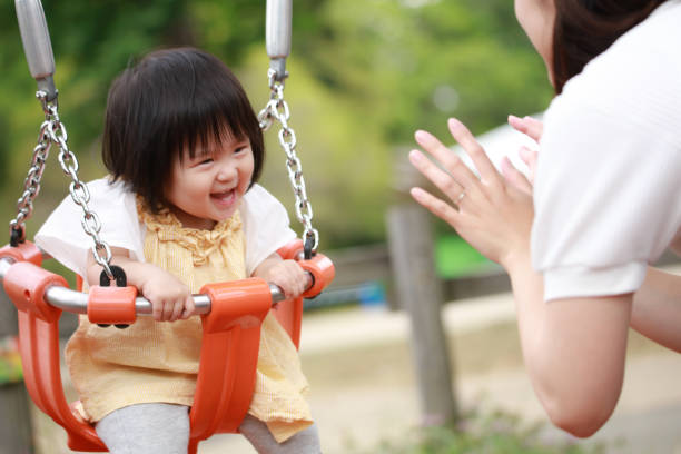 istock Parents and children playing on a swing 1306770979