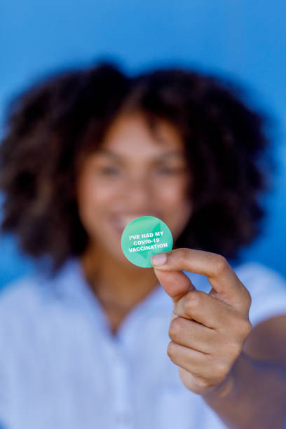 African Woman With COVID-19 Vaccine Sticker African Woman Proudly Displaying Her COVID-19 Vaccine Sticker - 'I've Had My Covid-19 Vaccination' herd immunity photos stock pictures, royalty-free photos & images