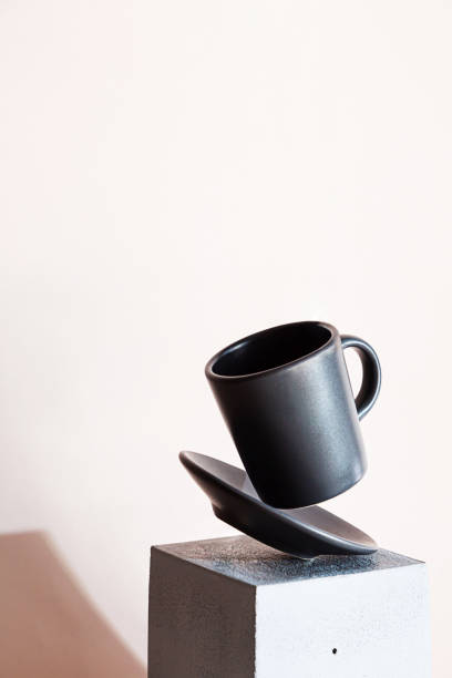istock Minimal modern still life with levitation of a cup of coffee. Creative composition with geometric shape cube and coffee cup 1306775500