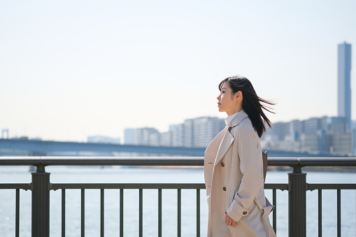 Positive image of businesswoman in waterfront area