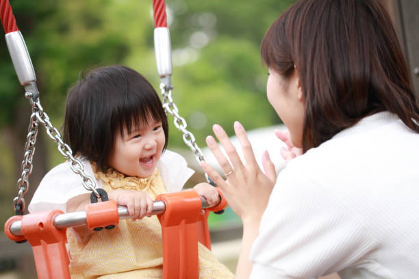 istock Parents and children playing on a swing 1306779829