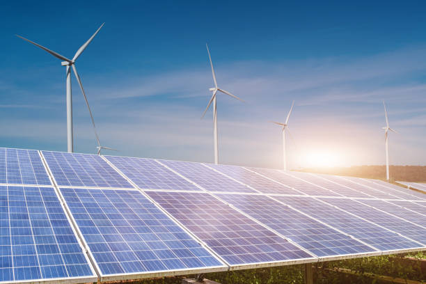 istock solar panels with wind turbines against blue sky background 1306788219