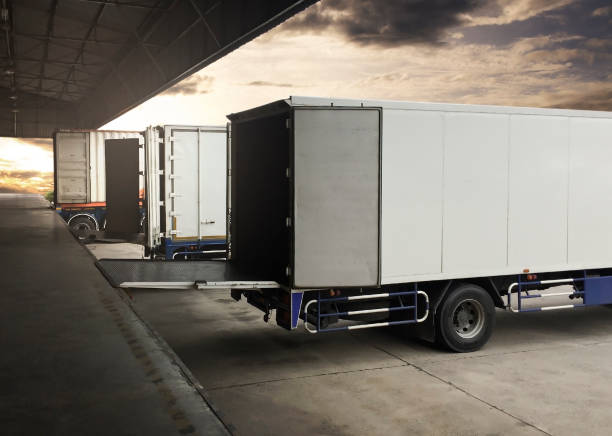 istock Cargo Container Truck Parked Loading at Dock Warehouse. Cargo Shipment. Industry Freight Truck Transportation. Shipping Warehouse Logistics. 1306788996